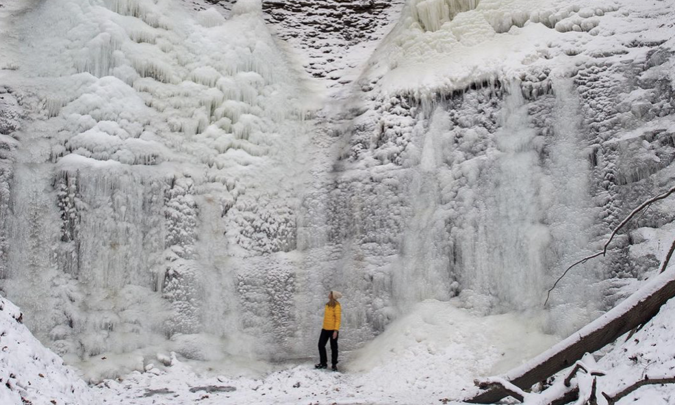 Jeri McMinn stands at the bottom of a huge ice formation. Jeri McMinn stands at the bottom of a huge ice formation.