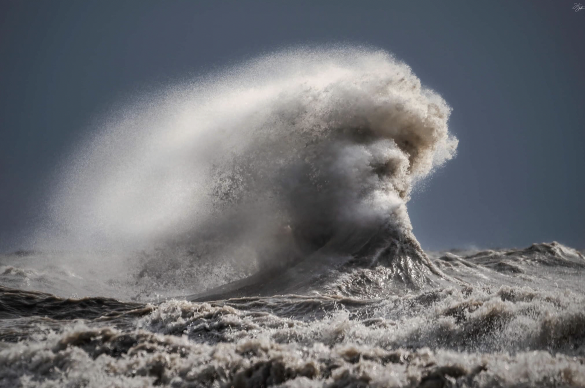 A crashing wave takes the form of a man's face. A crashing wave takes the form of a man's face.